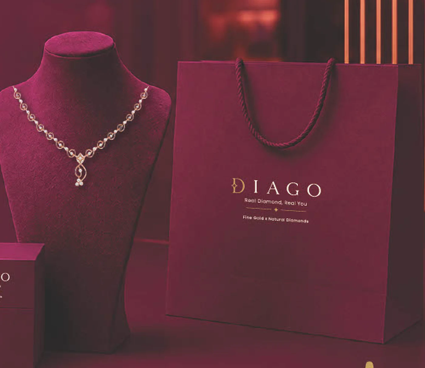 A DIAGO necklace on its counter display beside the signature box and bag